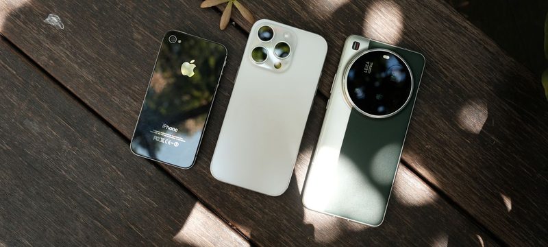 Three smartphones on a wooden table