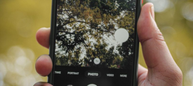 Hand holding an Android phone in camera mode