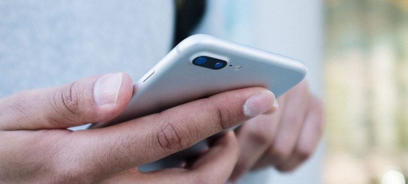 Hands holding an iPhone, close-up